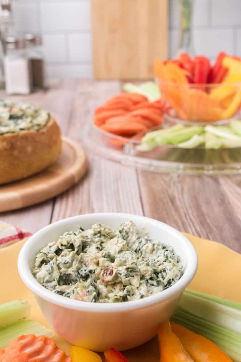 White bowl filled with spinach dip.