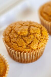 WW pumpkin muffins lined on a white plate.