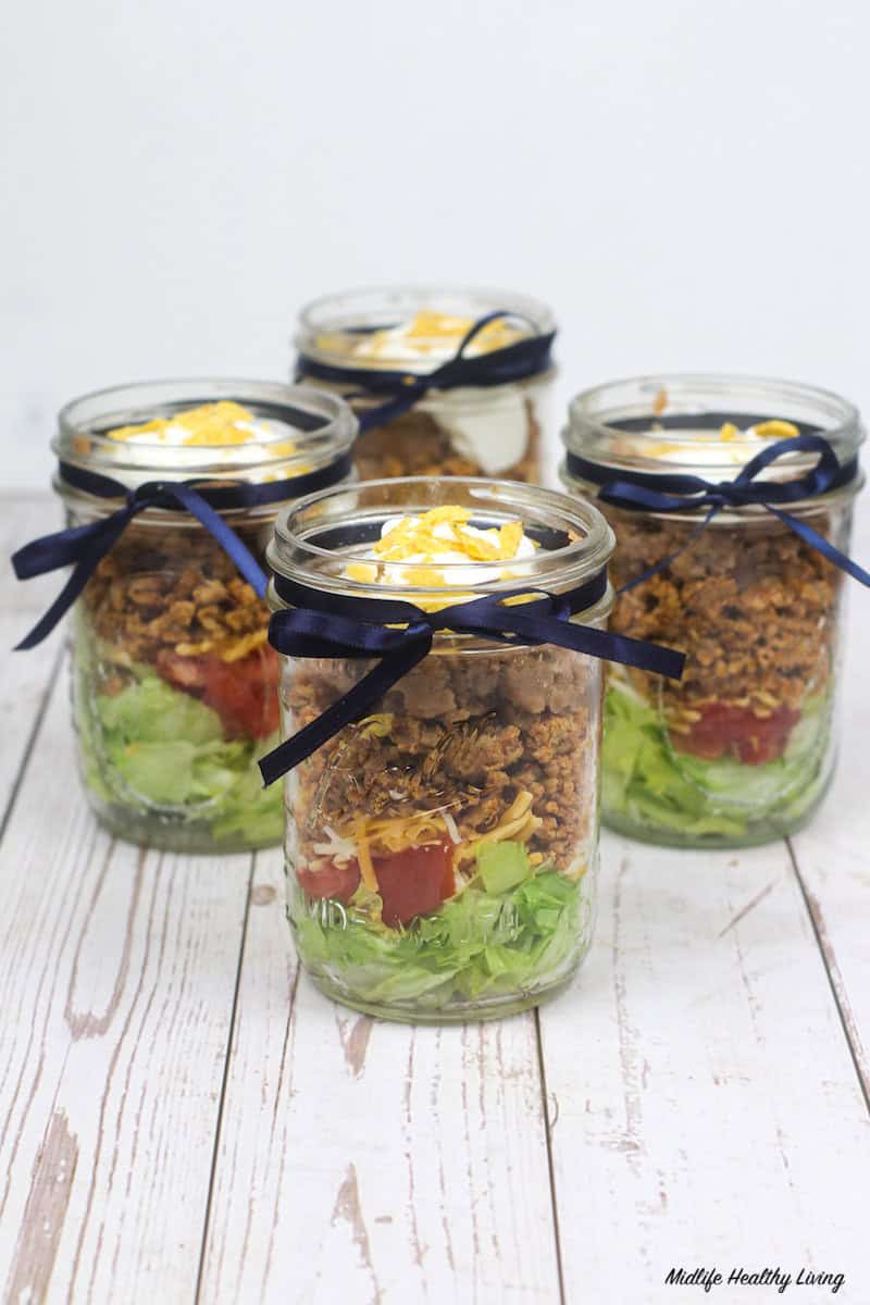 https://www.midlifehealthyliving.com/wp-content/uploads/2021/03/Finished-Taco-Salad-in-a-Jar-Ready-To-Eat.jpg