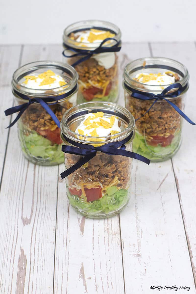 https://www.midlifehealthyliving.com/wp-content/uploads/2021/03/Top-Down-Taco-Salad-in-a-Jar-.jpg