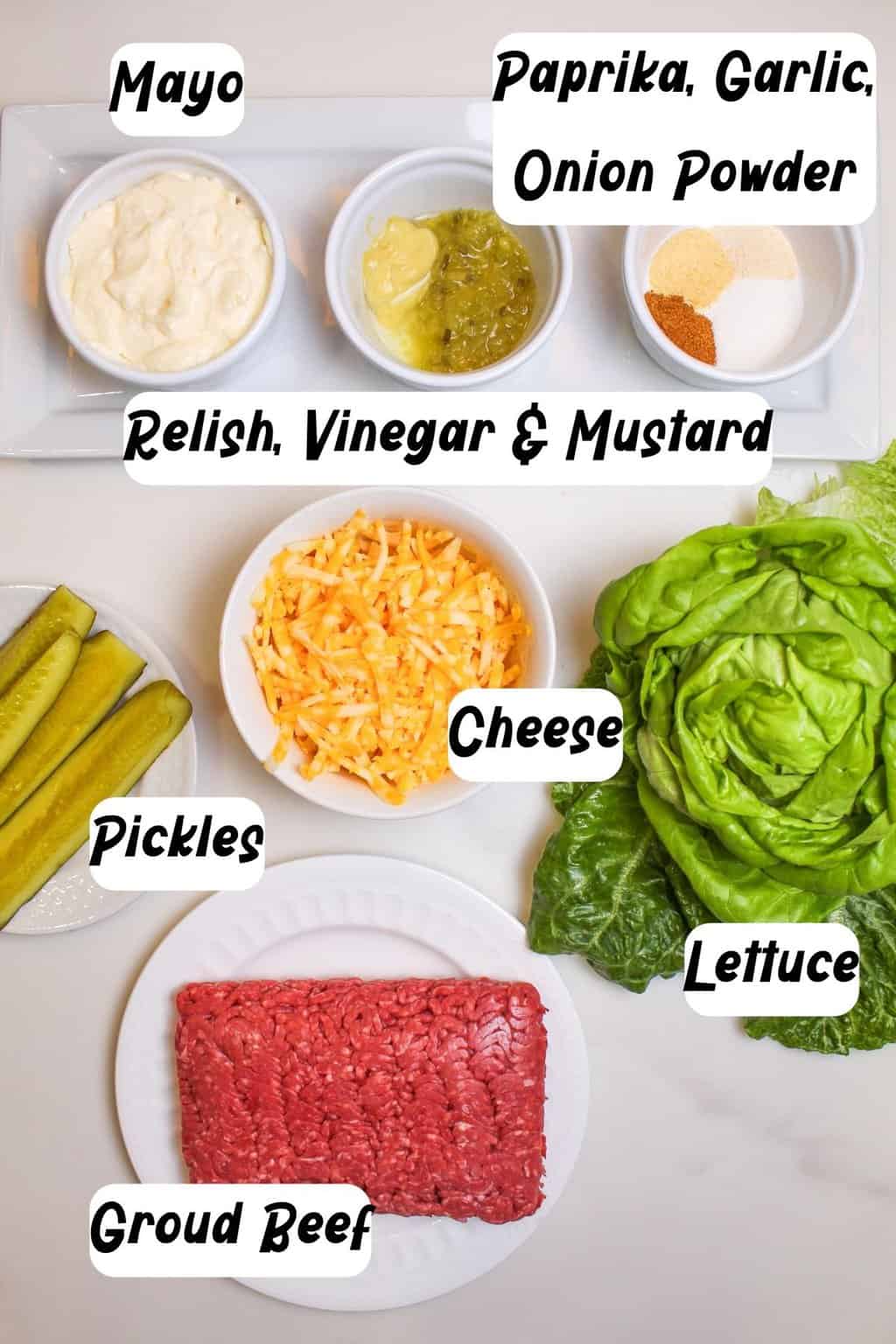 Ingredients needed to make this cheese burger salad. Mayo, paprika, garlic, onion powder, relish, vinegar, mustard, cheese, lettuce, pickles, ground beef.