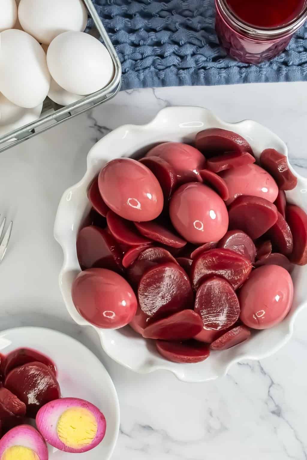 Red eggs served on a white plate.
