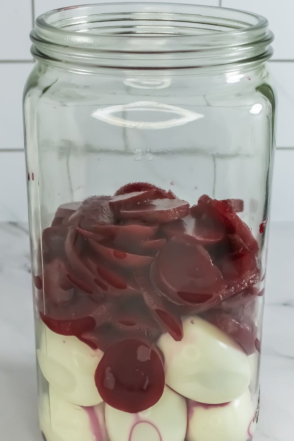Beets and eggs in a glass jar.