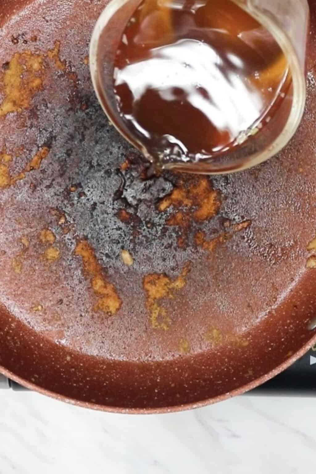 Preparing skillet for pork chops.