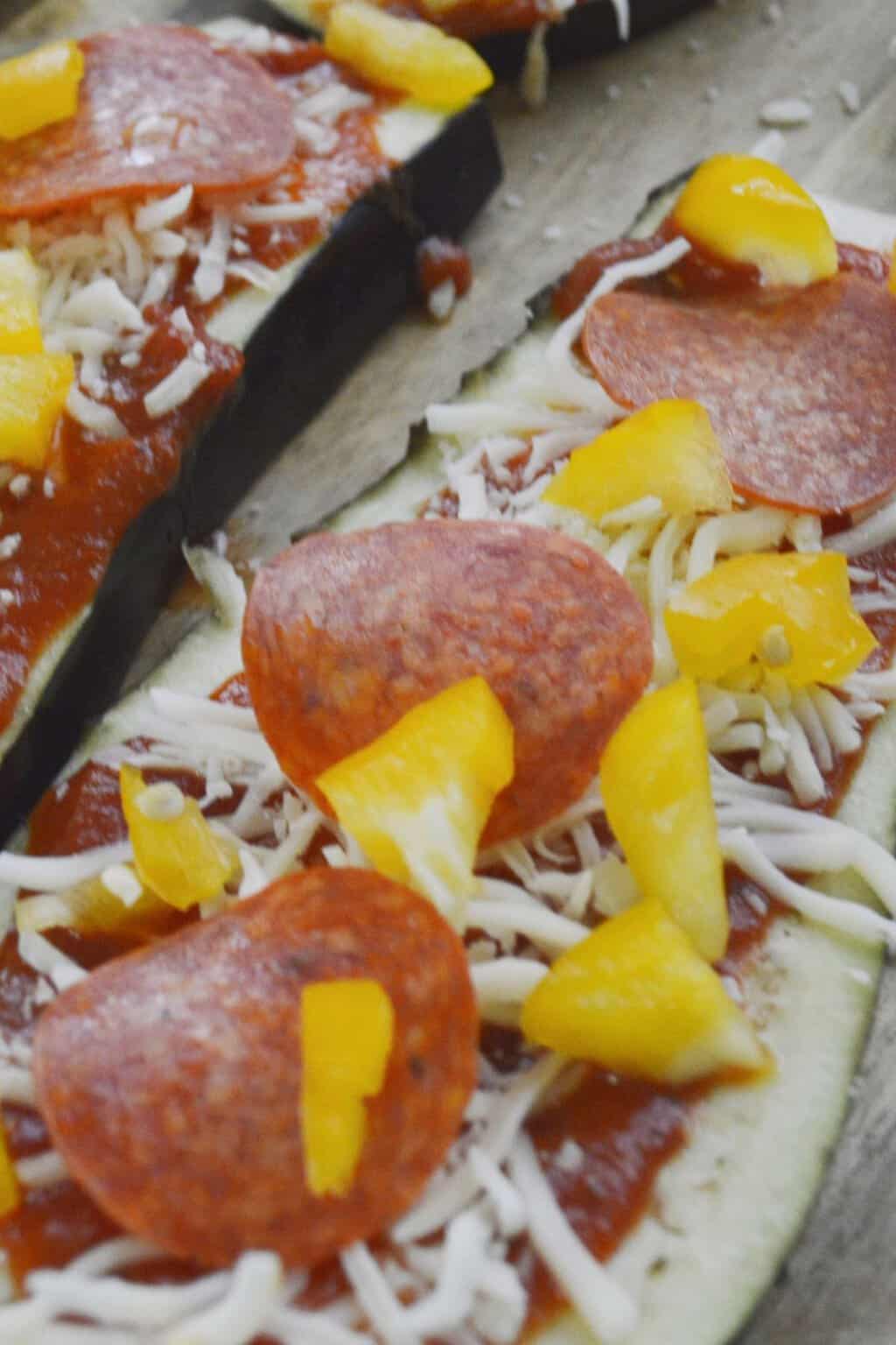 Yellow peppers added to eggplant pizza.