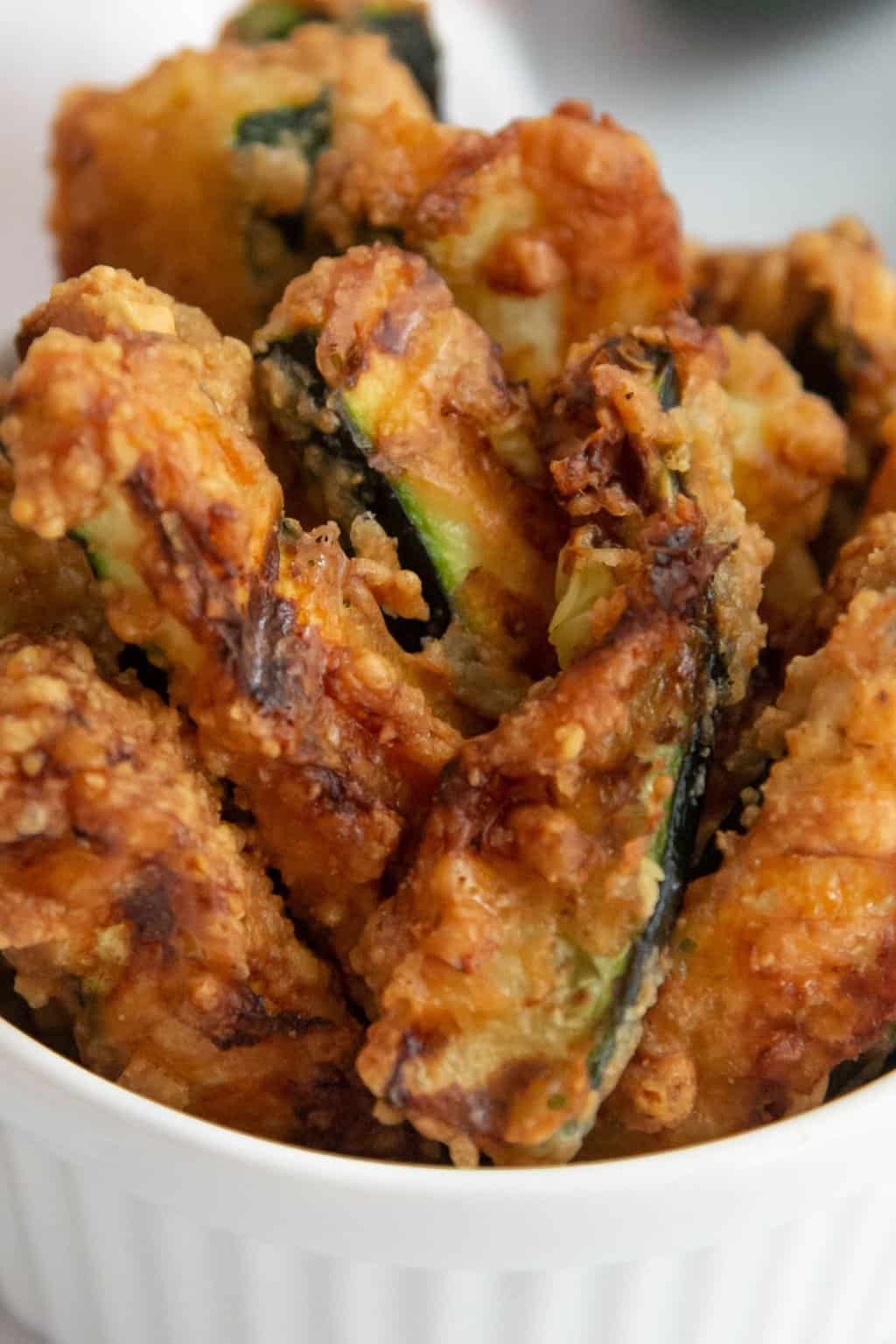 An up close photo of fried zucchini fries.