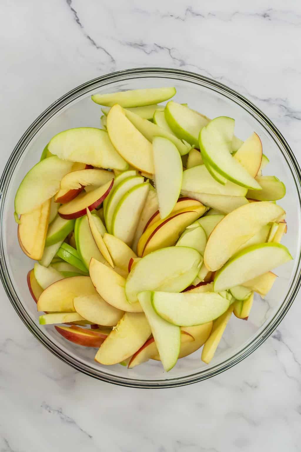 Slices of apples in a glass bowl.