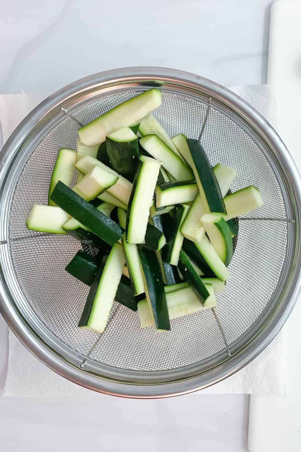 Washed zucchini slices drying.