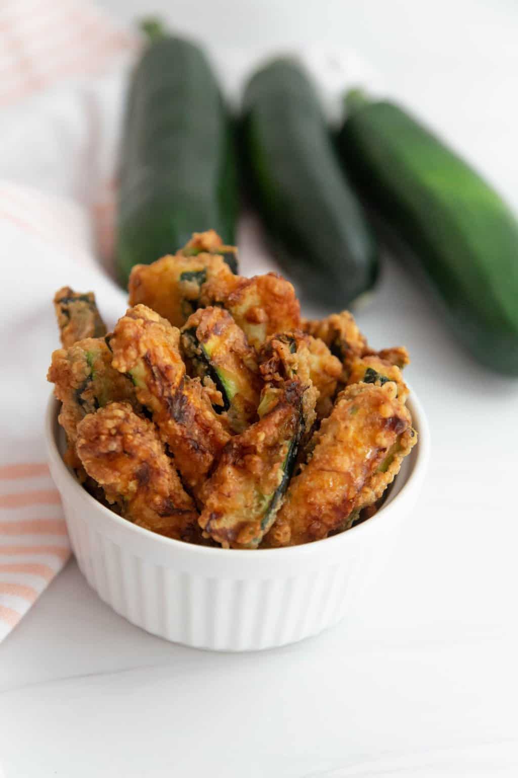 Zucchini fries in a small white dish.