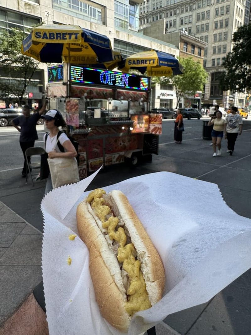 Grabbing A Dirty Water Dog From Street Carts